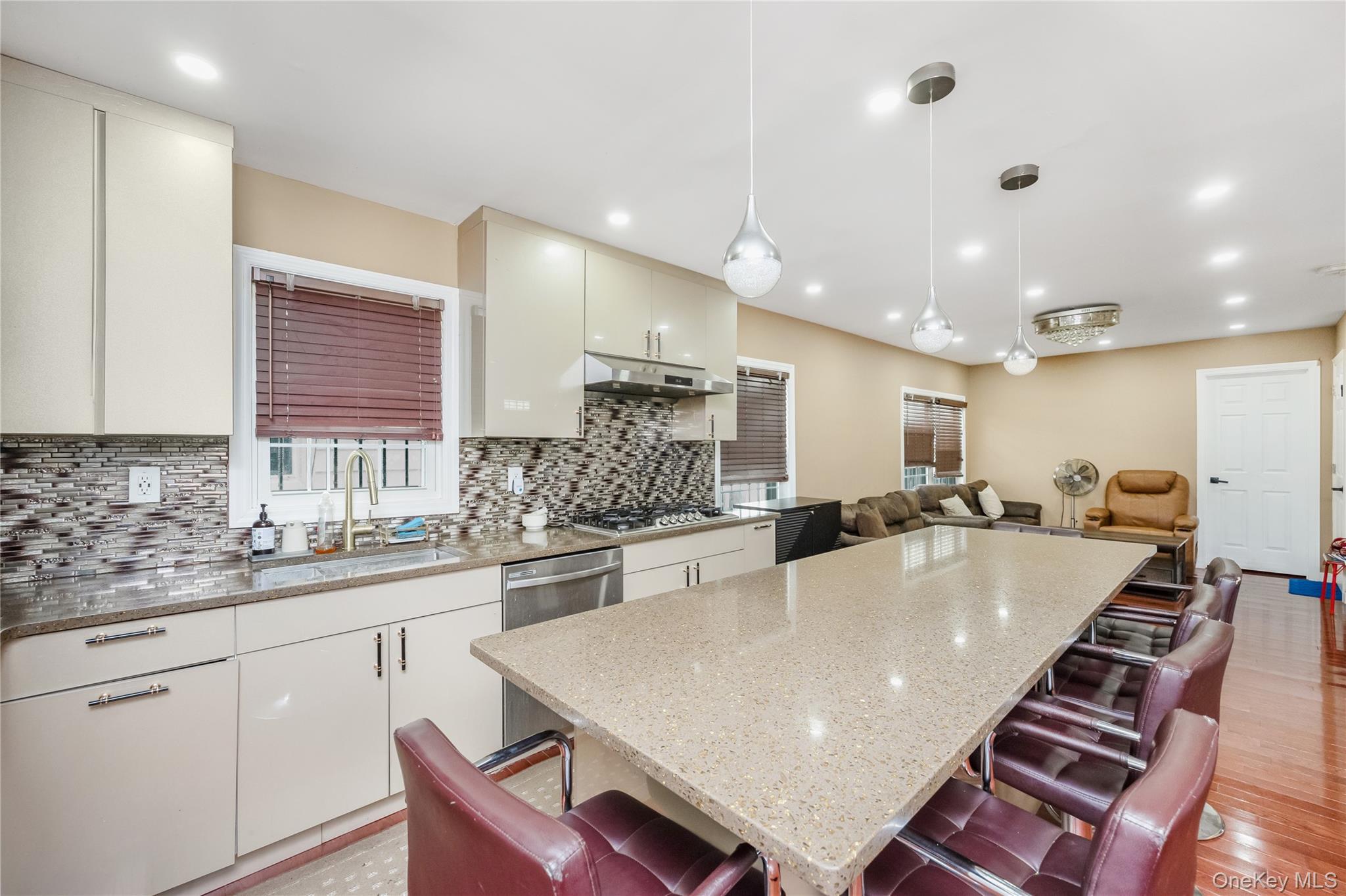 102-18 216th Street Queens, NY 11429 - Photo 22 of 23 a large kitchen with kitchen island a sink table and chairs