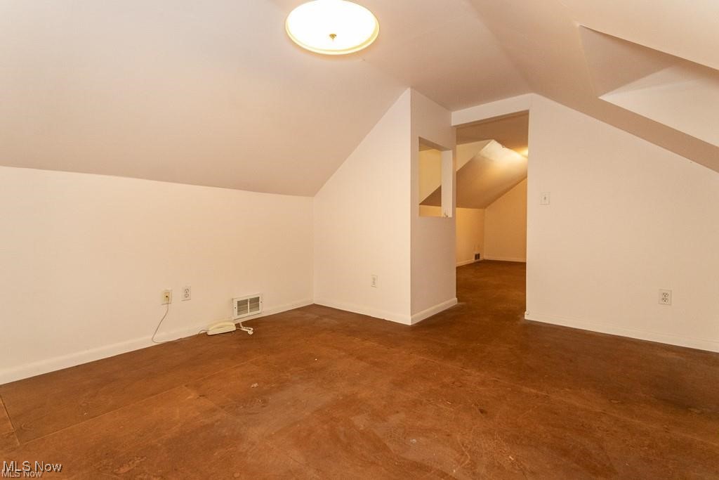 986 Woodview Road Cleveland, OH 44121 - Photo 8 of 9 Additional living space featuring lofted ceiling and concrete flooring