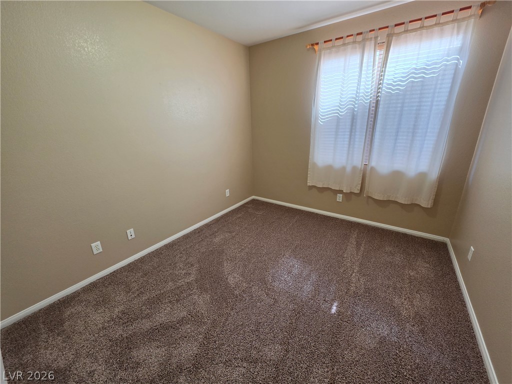 209 Opera House Street Henderson, NV 89012 - Photo 28 of 45 Plush carpeting and a wide window define this cozy bedroom space.