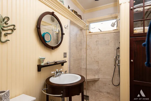 a bathroom with a sink a toilet and a mirror