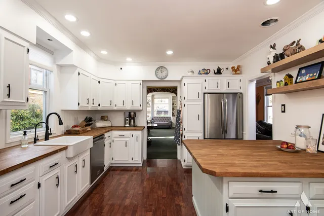 a kitchen with stainless steel appliances granite countertop a sink dishwasher stove and oven