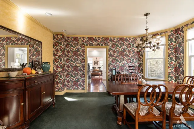 a view of a dining room with furniture and chandelier