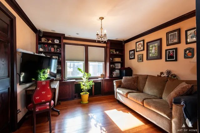 a living room with furniture a window and a flat screen tv