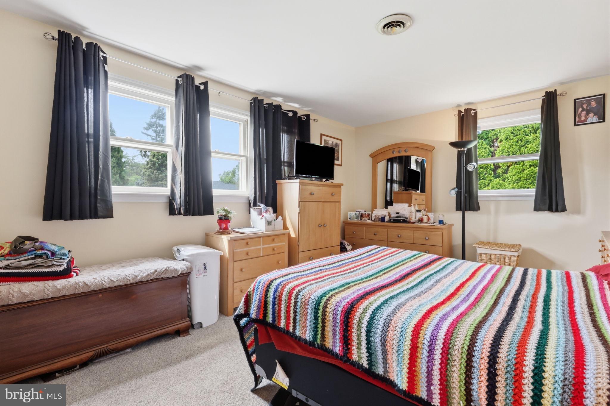 1413 Poplar Road Feasterville-Trevose, PA 19053 - Photo 13 of 35 a bedroom with a bed and large windows