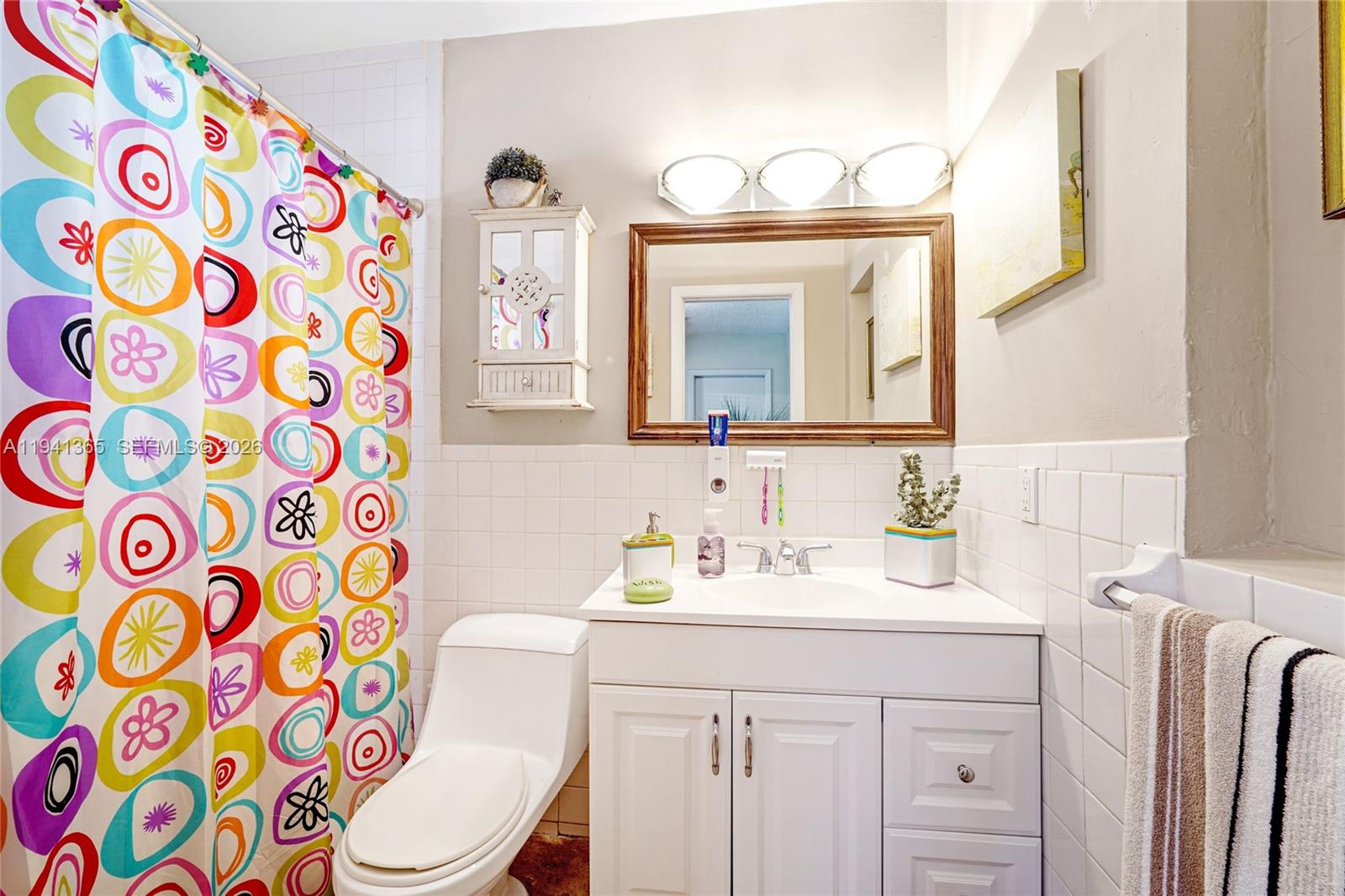 7256 Southwest 16th Street Miami, FL 33155 - Photo 20 of 25 a bathroom with a sink a toilet and a mirror