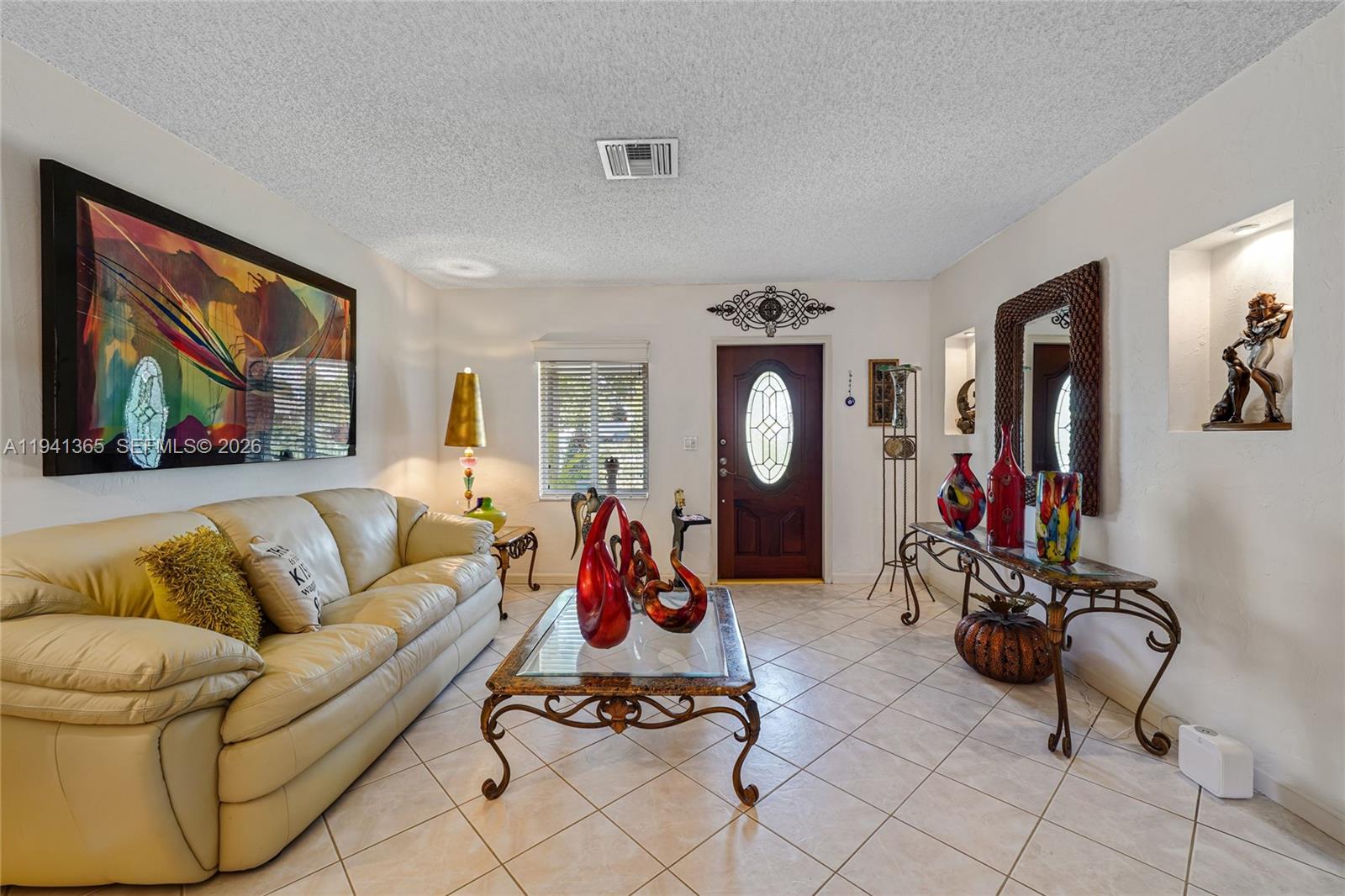 7256 Southwest 16th Street Miami, FL 33155 - Photo 3 of 25 a living room with furniture a flat screen tv and a window