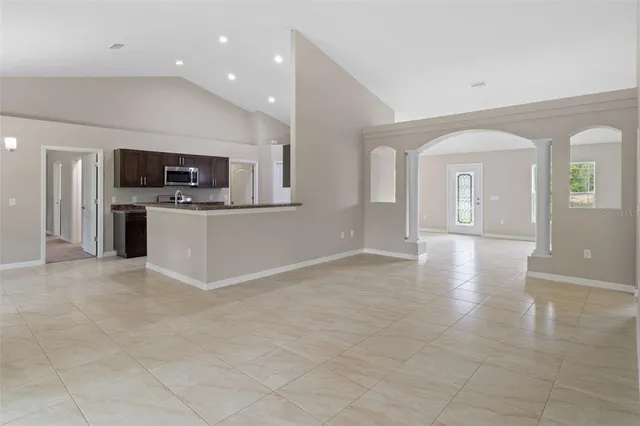 a view of kitchen with microwave and refrigerator