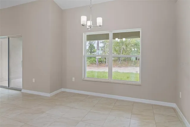 a large kitchen with stainless steel appliances a large counter top a stove a microwave a sink and dishwasher