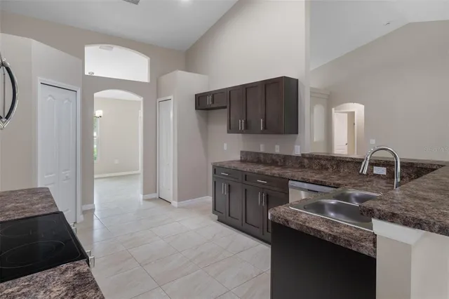 a kitchen with a sink and a stove top oven