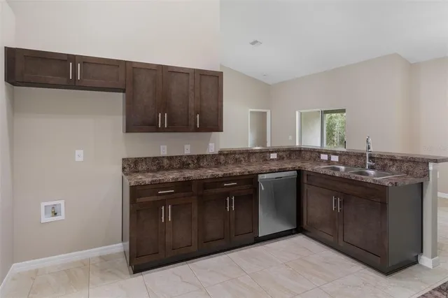 a kitchen with stainless steel appliances granite countertop a stove a microwave and a sink