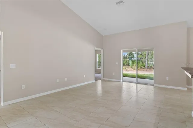 an empty room with windows and mirror