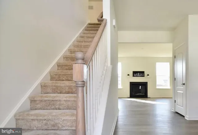 a view of entryway and hall with wooden floor