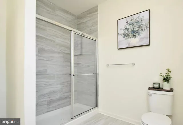 a bathroom with a toilet and a shower