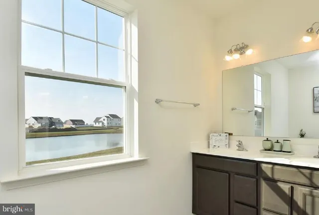 a bathroom with a sink vanity and mirror