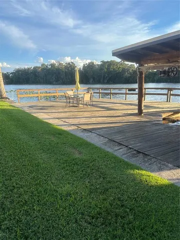 a view of a swimming pool with an outdoor seating yard and mountain view in back
