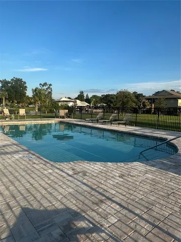 a view of a swimming pool with a yard