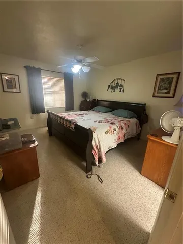 a bedroom with a bed and window