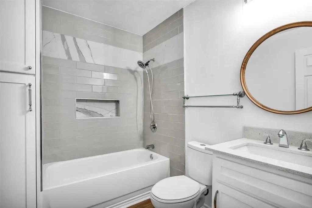 1915 Shaw Street Dallas, TX 75212 - Photo 13 of 34 a bathroom with a granite countertop sink toilet and shower