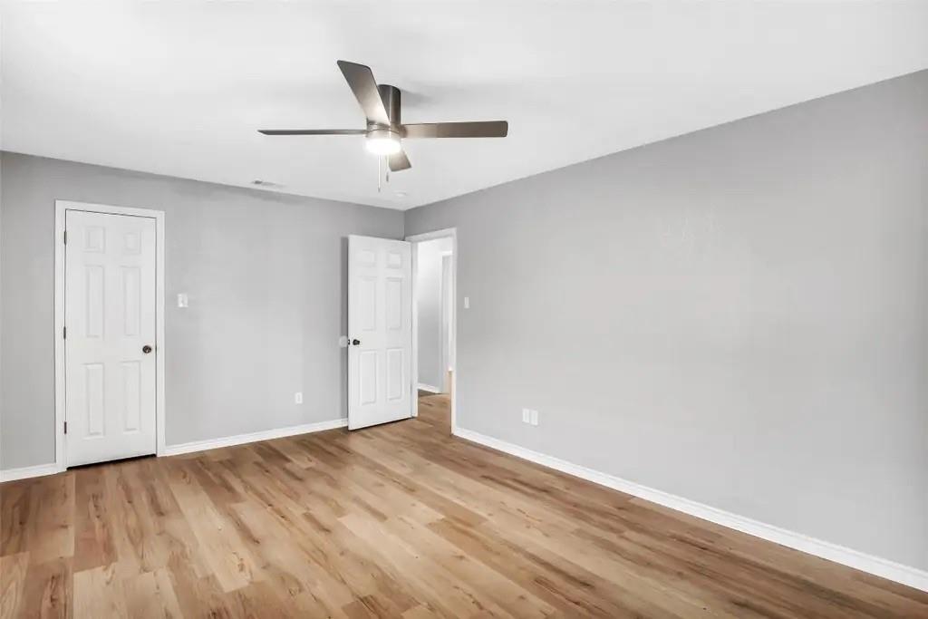 1915 Shaw Street Dallas, TX 75212 - Photo 18 of 34 an empty room with wooden floor ceiling fan and windows