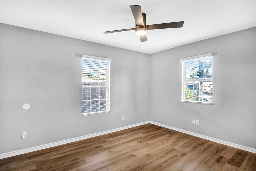 1915 Shaw Street Dallas, TX 75212 - Photo 19 of 34 a view of an empty room with wooden floor and a window