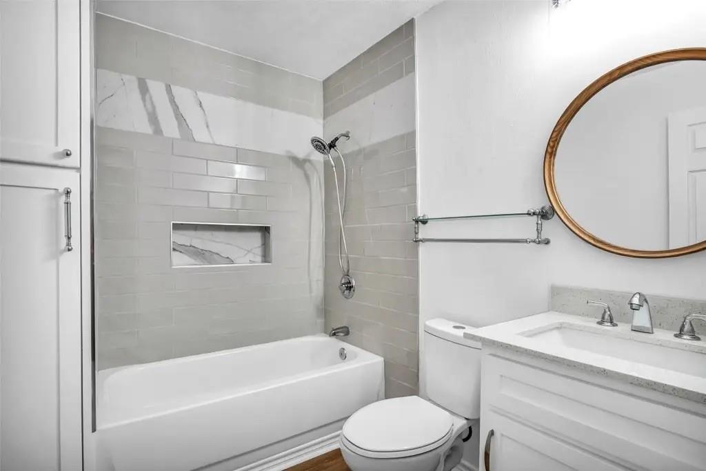 1915 Shaw Street Dallas, TX 75212 - Photo 21 of 34 a bathroom with a granite countertop sink toilet and shower