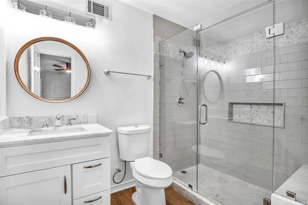 1915 Shaw Street Dallas, TX 75212 - Photo 23 of 34 a bathroom with a toilet sink vanity granite and shower