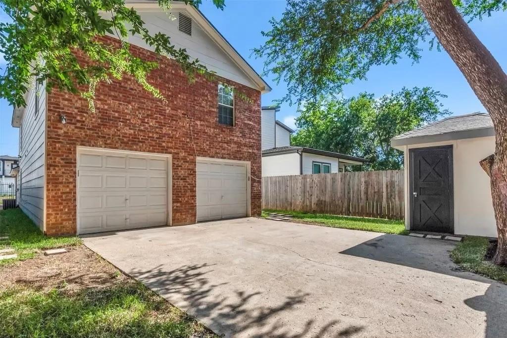1915 Shaw Street Dallas, TX 75212 - Photo 31 of 34 a front view of a house with a yard and garage