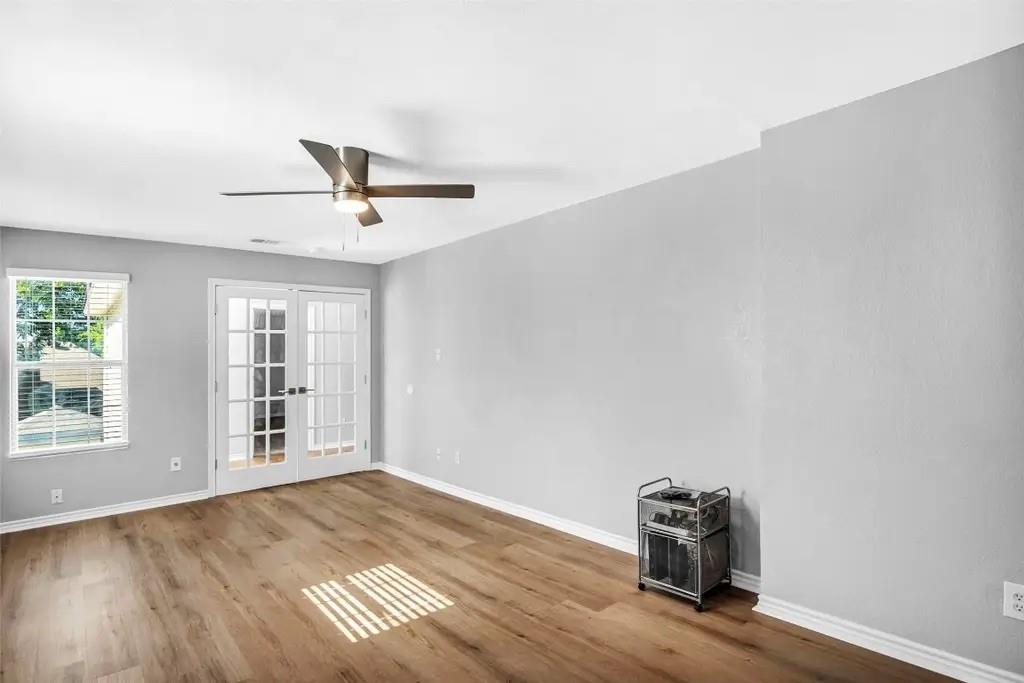 1915 Shaw Street Dallas, TX 75212 - Photo 5 of 34 an empty room with wooden floor and windows