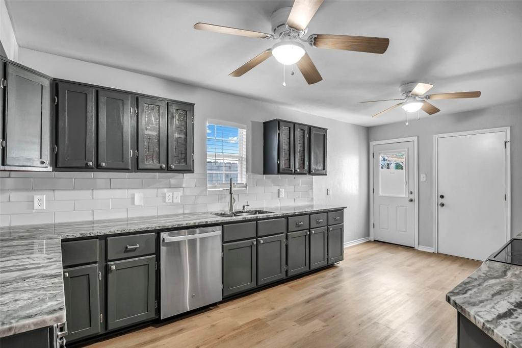 1915 Shaw Street Dallas, TX 75212 - Photo 9 of 34 a spacious bathroom with a granite countertop sink and a large mirror