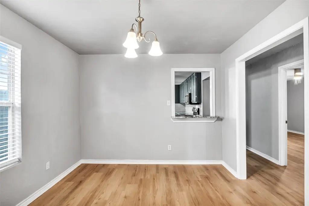 1915 Shaw Street Dallas, TX 75212 - Photo 10 of 34 a view of a room with wooden floor and windows