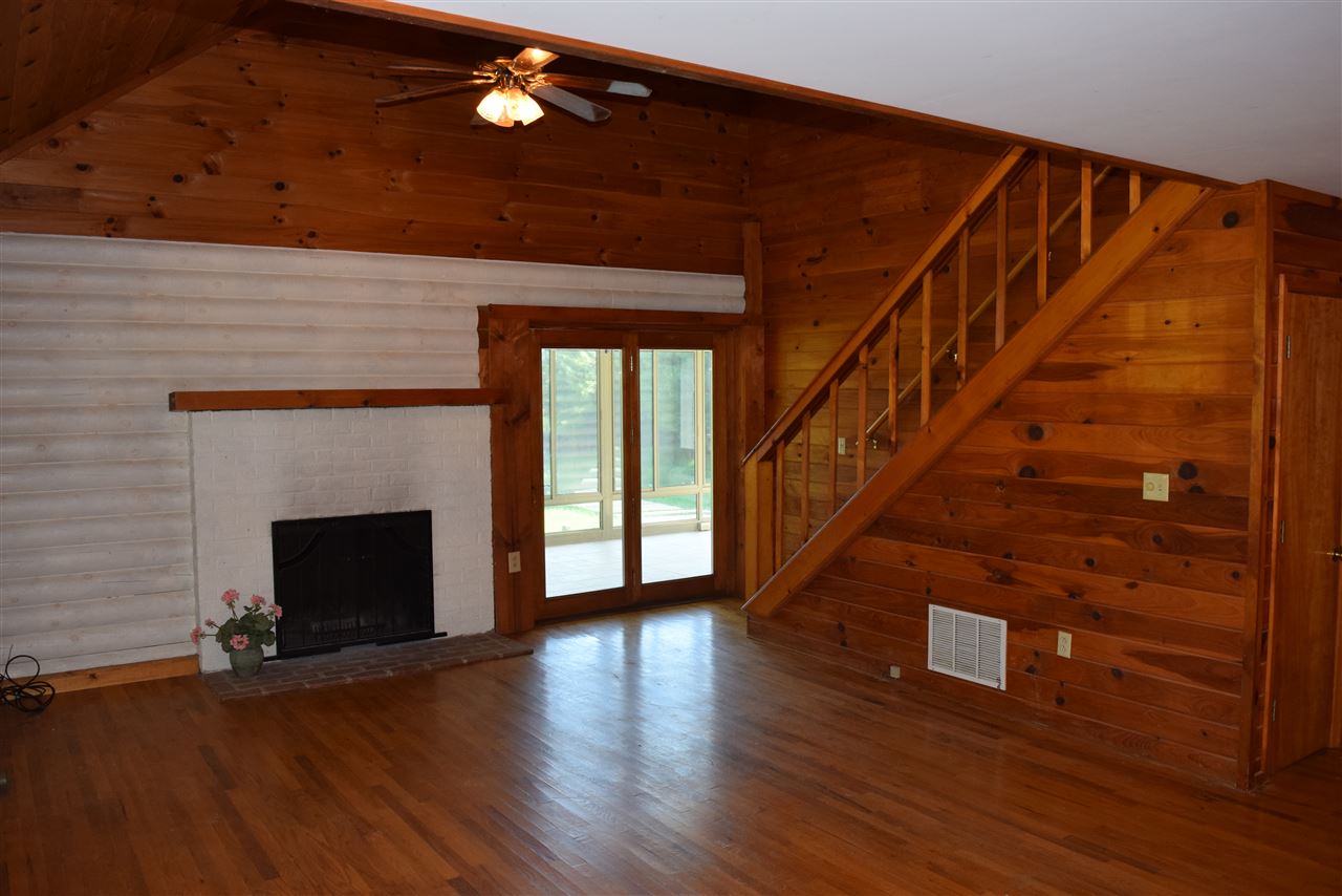 382 McKamy Springs Road Middlebrook, VA 24459 - Photo 11 of 48 a view of an empty room with wooden floor fireplace and a window