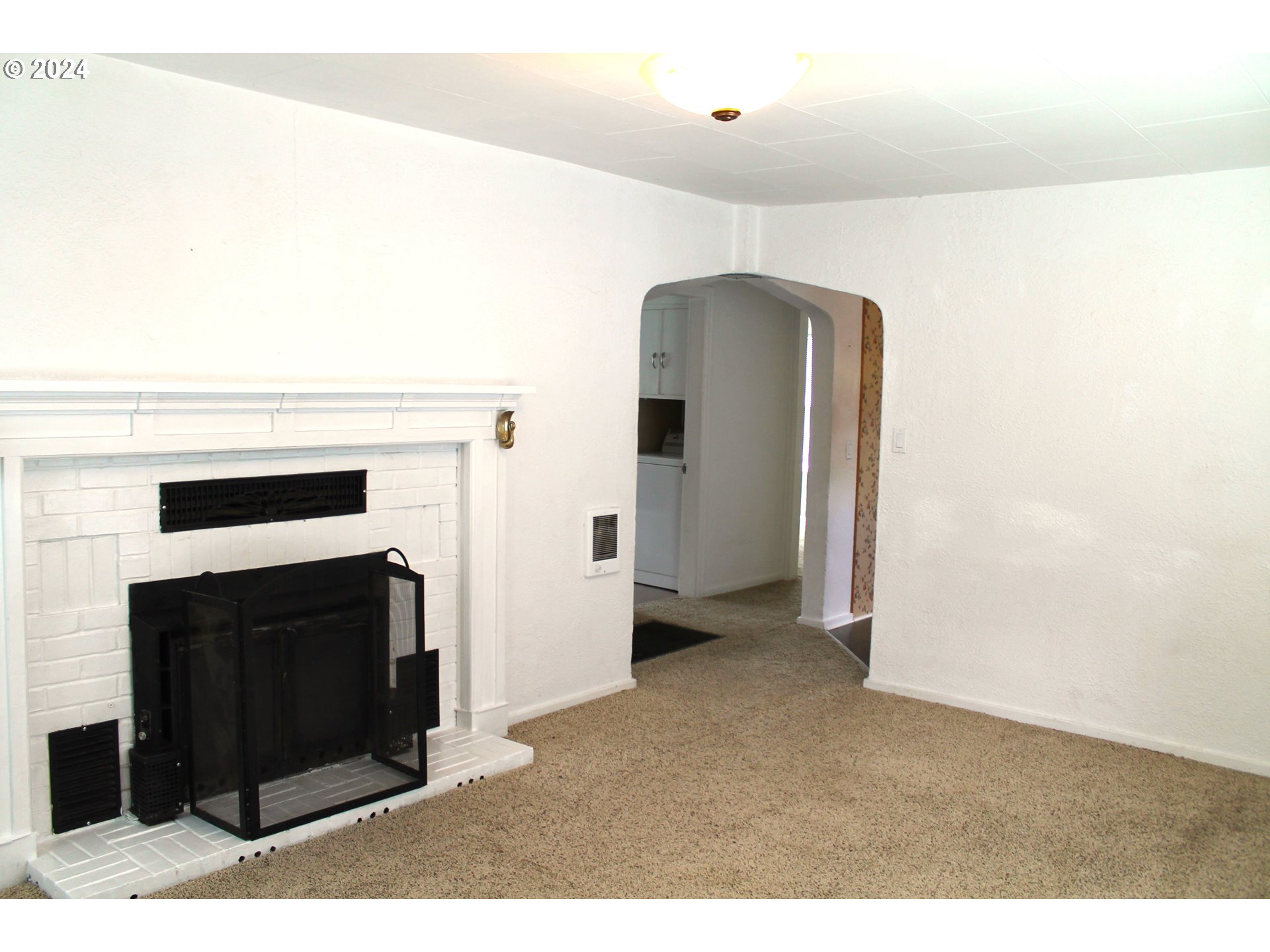 757 South Bridge Street Prairie City, OR 97869 - Photo 9 of 19 a view of an empty room with a fireplace
