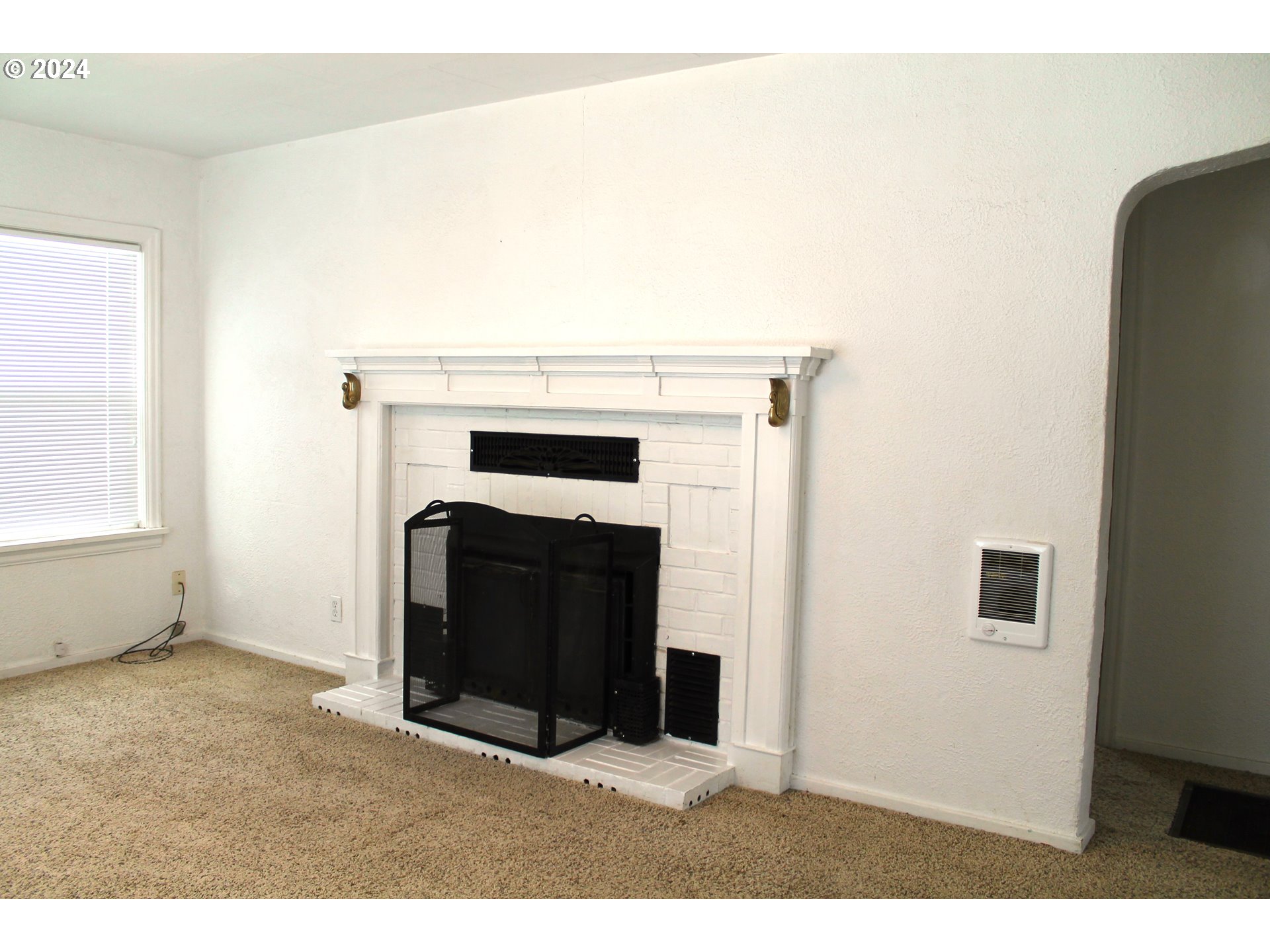 757 South Bridge Street Prairie City, OR 97869 - Photo 10 of 19 a living room with a fireplace and a table