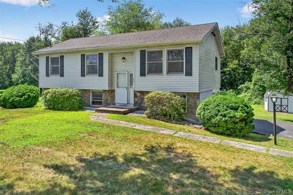 a view of a house with a yard and plants
