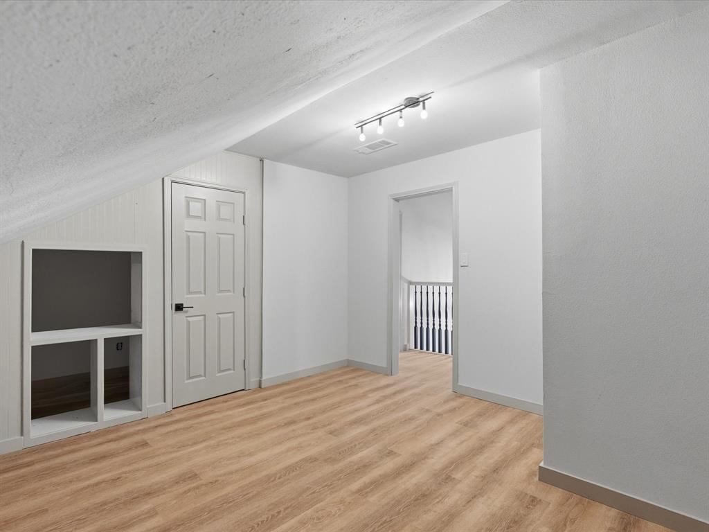 289 County Road 4655 Rhome, TX 76078 - Photo 21 of 34 Featuring wood-finish flooring, white walls, and built-in shelving