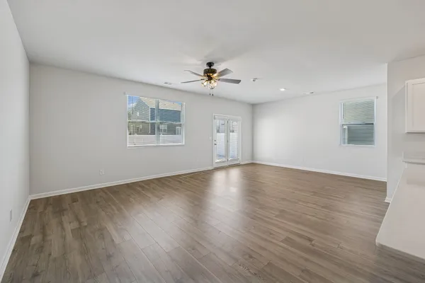 wooden floor in an empty room with a window