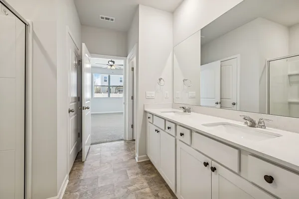 a spacious bathroom with a double vanity sink mirror and double