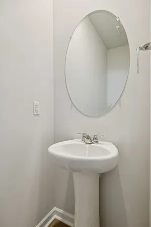 a bathroom with a sink a mirror and a toilet