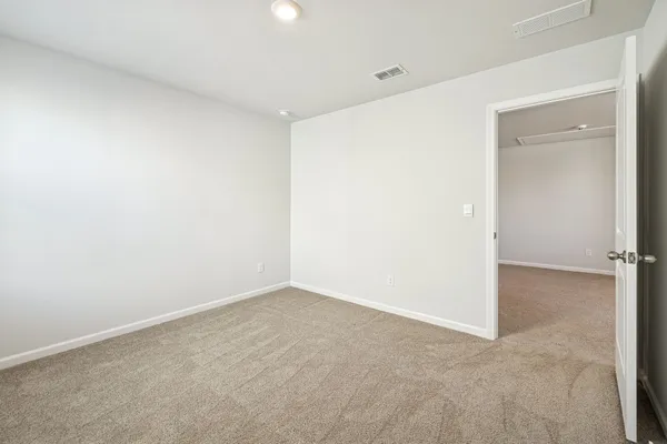 an empty room with a window and a ceiling fan