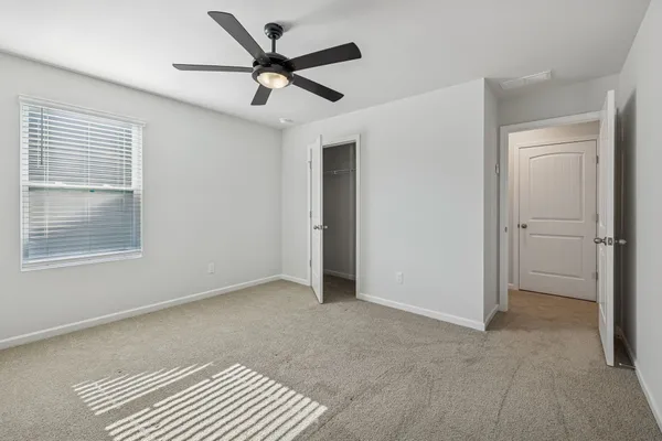 a view of room with a ceiling fan