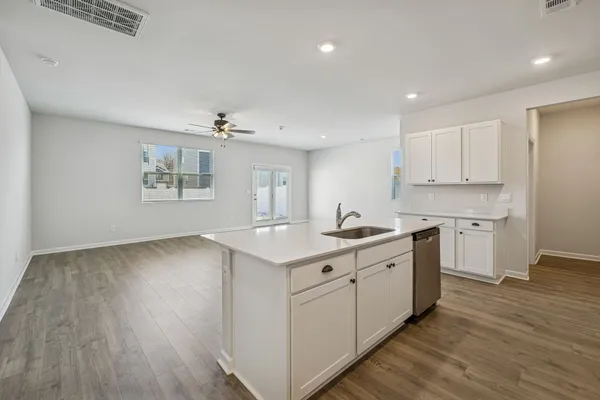 a kitchen with a sink stove and cabinets