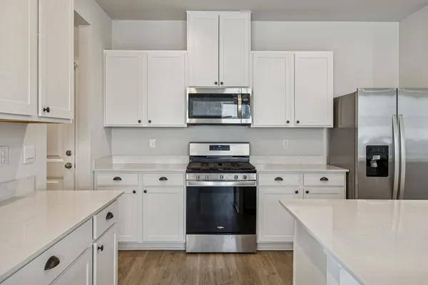 a kitchen with cabinets appliances and a sink