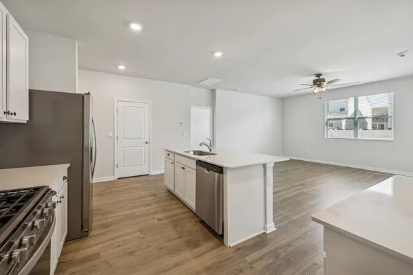 a kitchen with stainless steel appliances a stove and a refrigerator