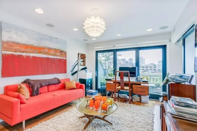 a living room with furniture a rug and a large window