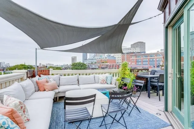 a balcony with furniture and a floor to ceiling window