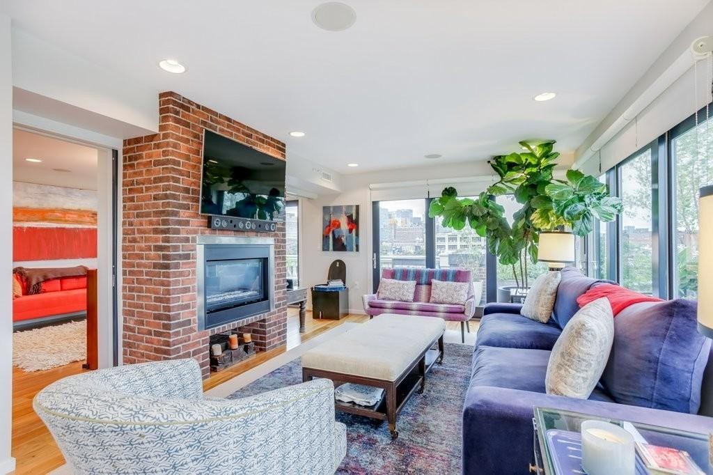 79 Chandler Street, Unit 9 Boston, MA 02116 - Photo 2 of 19 a living room with furniture a flat screen tv and a fireplace