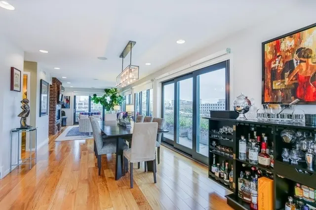 a dining hall with stainless steel appliances granite countertop a stove and refrigerator