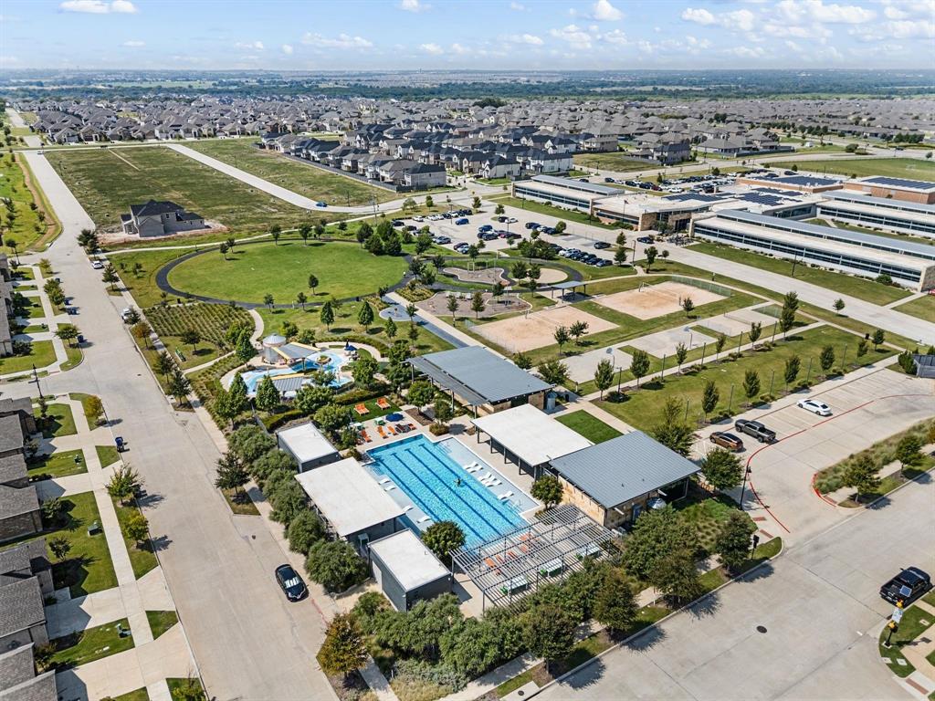 7416 Sequoia Rdg Road Little Elm, TX 76227 - Photo 35 of 37 Community amenities featuring a large outdoor swimming pool, a separate children's splash pad, sports courts, and expansive green spaces