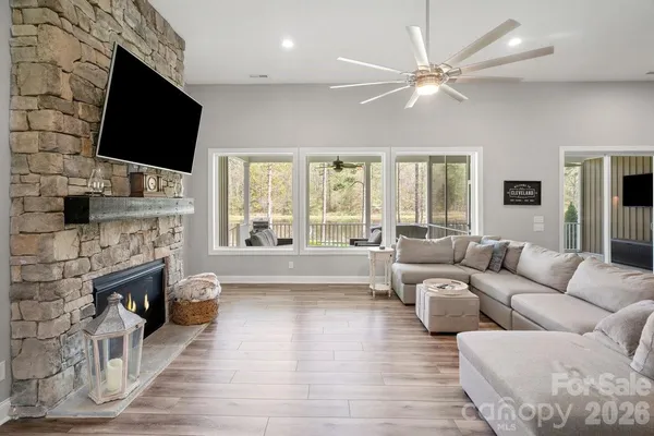 a living room with fireplace furniture and a flat screen tv