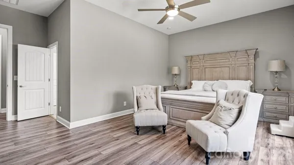 a bedroom with furniture and wooden floor